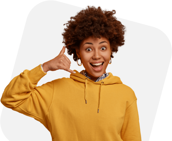 A smiling person making a "call me" hand gesture